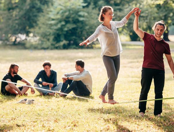 Young people with slackline in the park