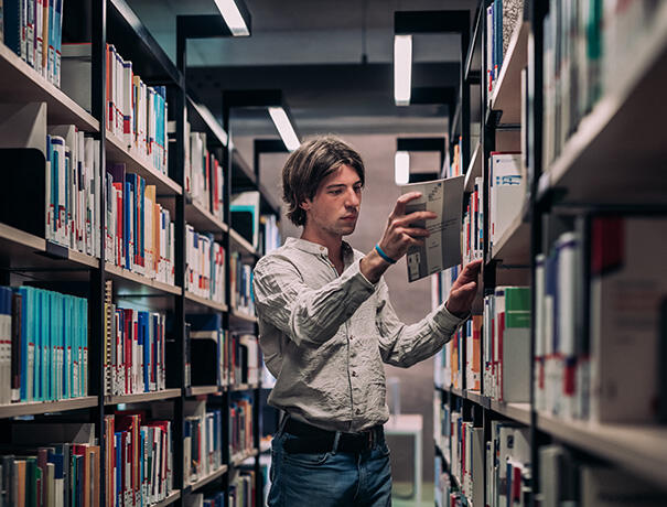 Student between bookshelves