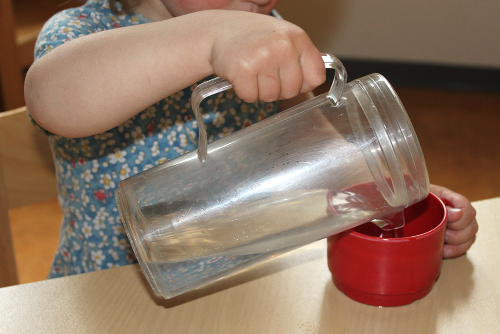 Child pours drink by himself
